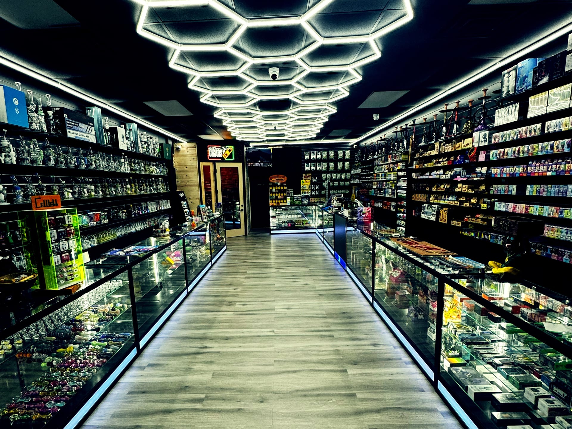 Retail aisle looking toward the cigar room at Aura Vape and Cigar in Rock Hill, SC.