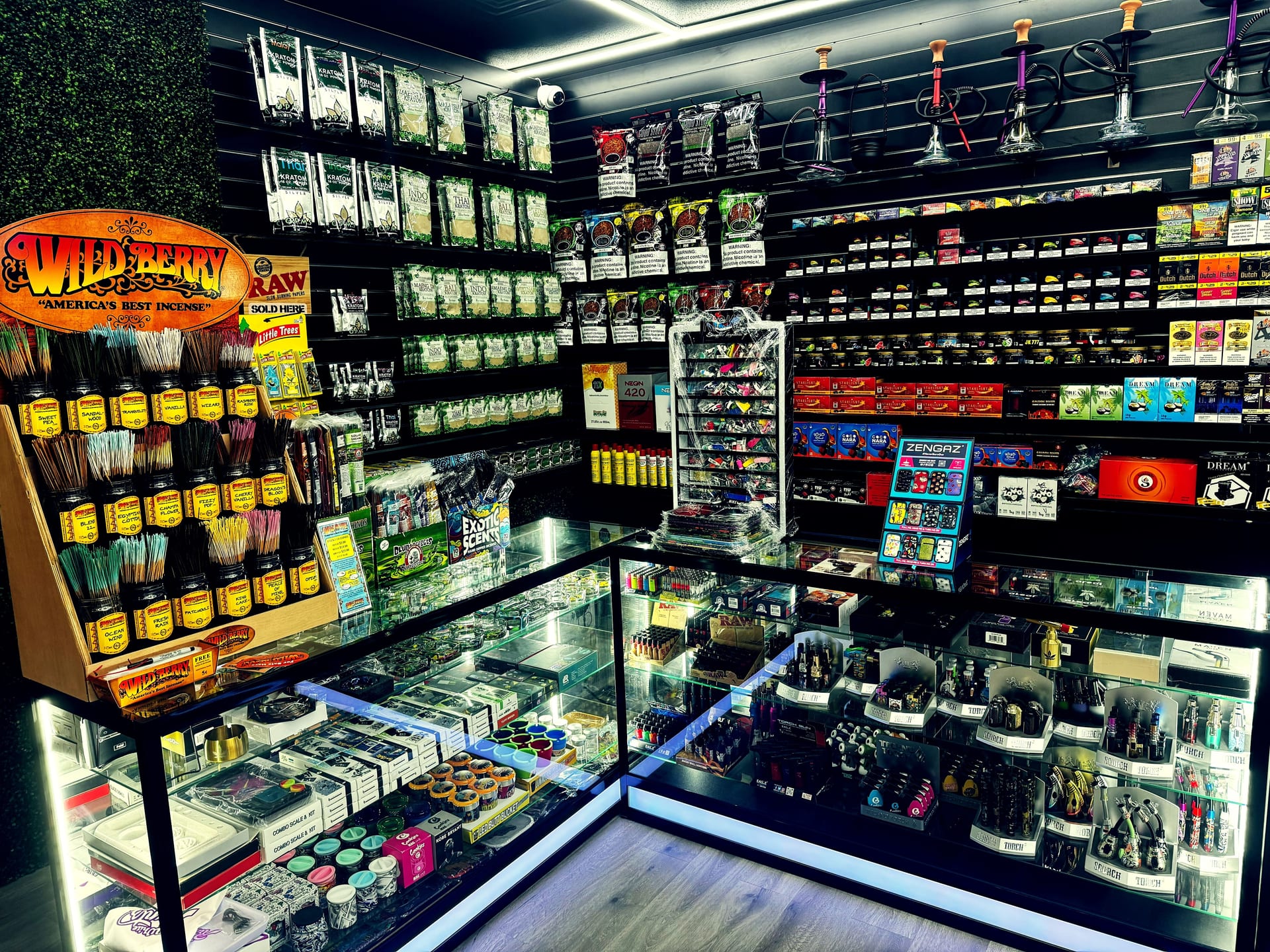 Wild Berry incense, kratom pouches, and glass counter displays.