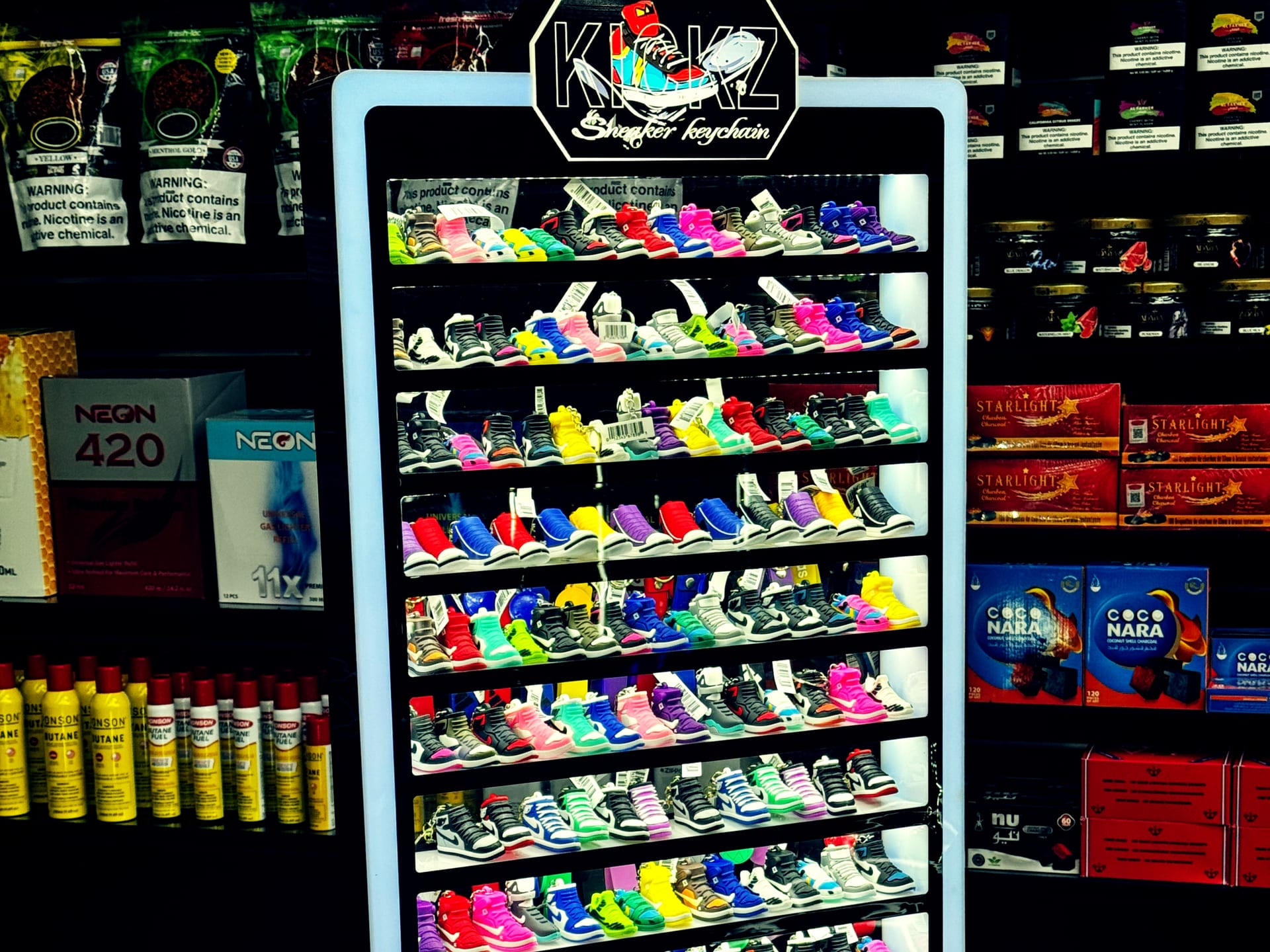 Kicks Sneaker Keychain illuminated multi-tier display stand.